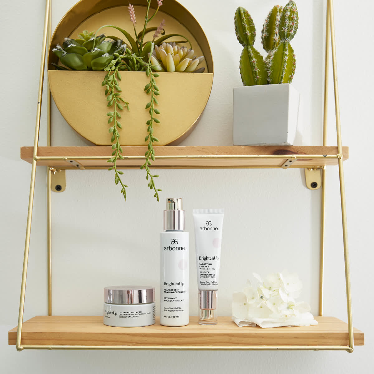 Arbonne skincare on a hanging wooden shelf with trailing plants